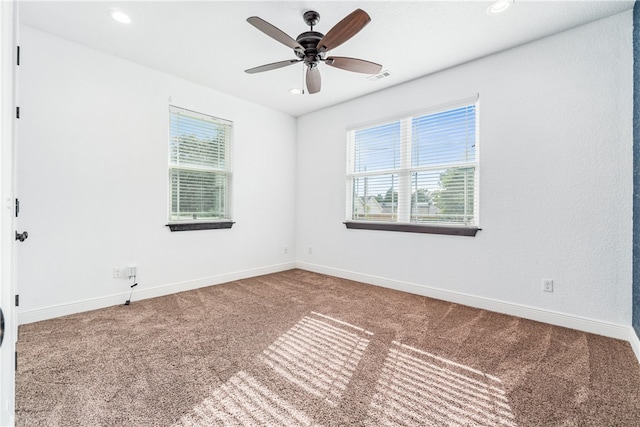 carpeted empty room featuring ceiling fan