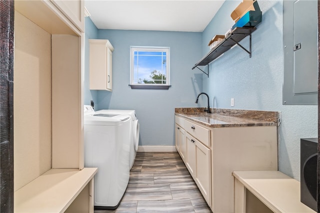 washroom with cabinets, sink, and independent washer and dryer