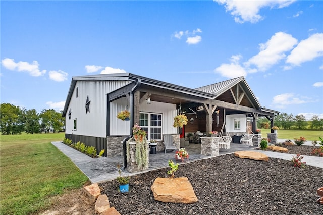 exterior space with a patio area and a lawn