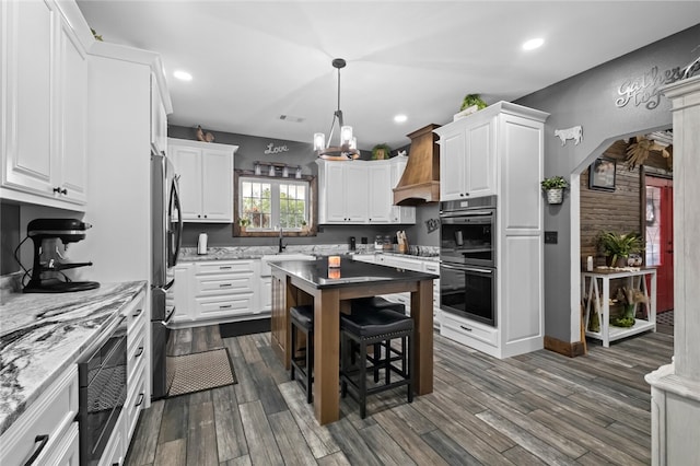 kitchen featuring white cabinets, custom exhaust hood, and dark hardwood / wood-style floors