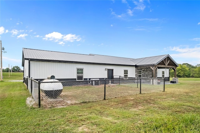 rear view of house featuring a lawn