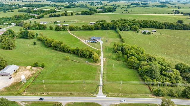 birds eye view of property with a rural view