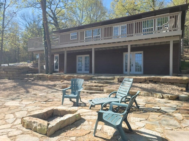 back of property with french doors, a patio, and a deck