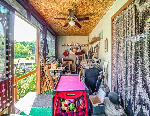 sunroom with a ceiling fan