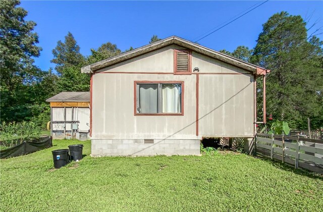 view of side of home featuring a lawn