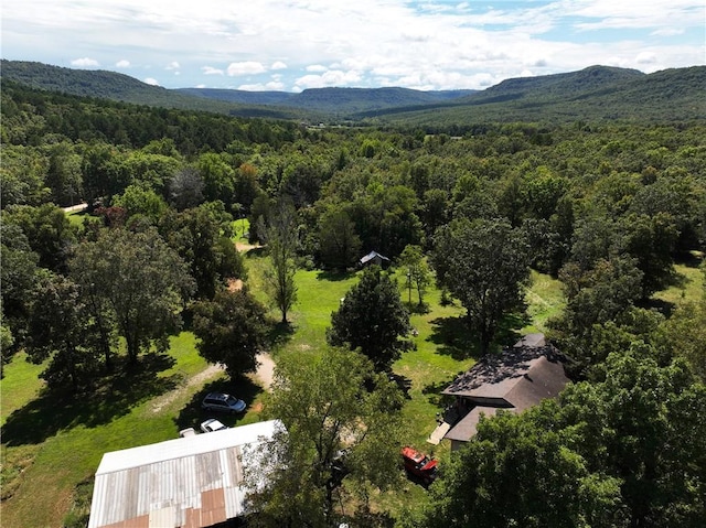 birds eye view of property featuring a mountain view and a wooded view