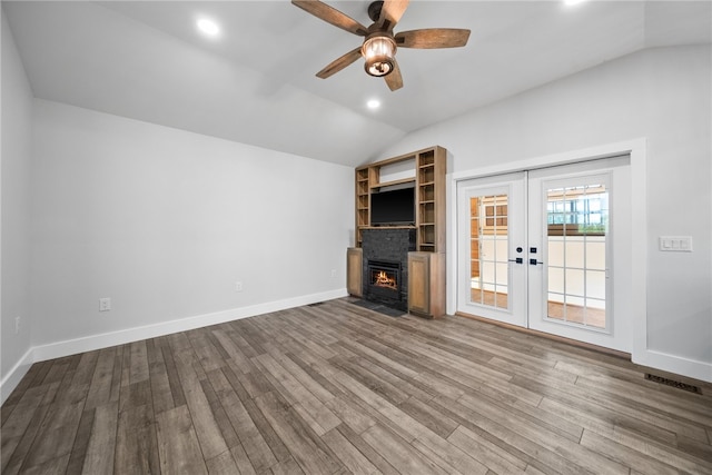 unfurnished living room with hardwood / wood-style floors, ceiling fan, and vaulted ceiling