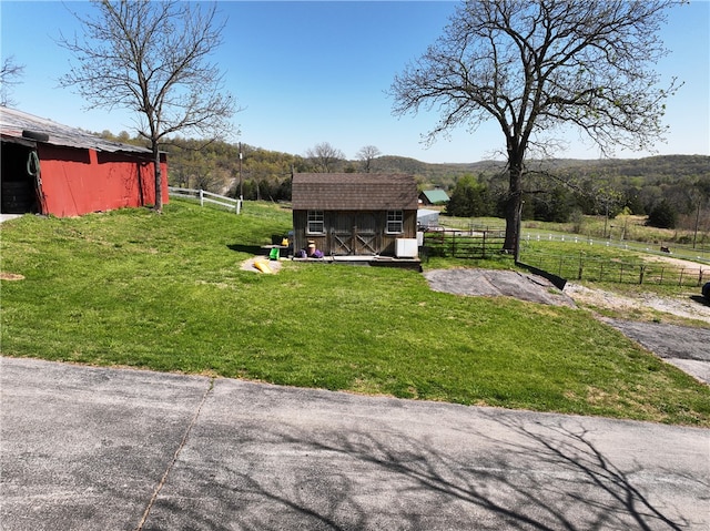 view of yard with a rural view and a storage unit