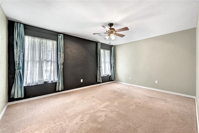 empty room featuring carpet flooring and ceiling fan