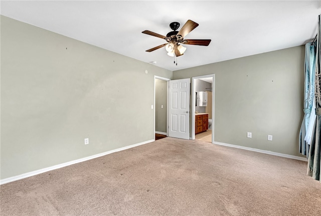 carpeted spare room featuring ceiling fan