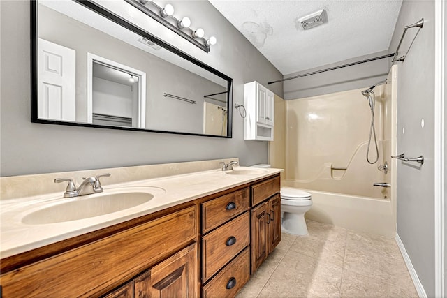 full bathroom with a textured ceiling, vanity, toilet,  shower combination, and tile patterned floors