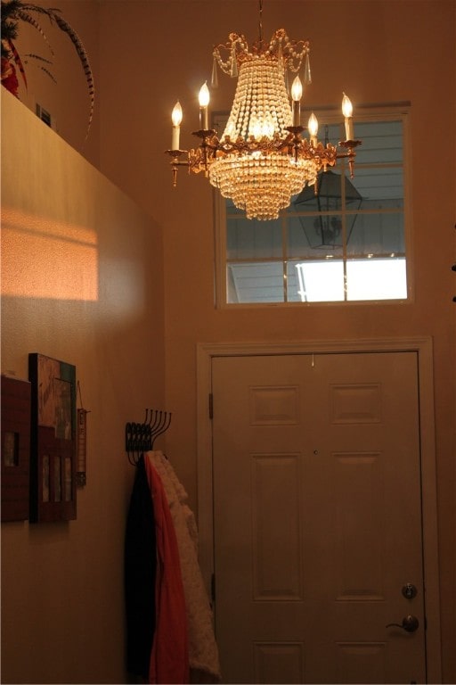 entryway with a chandelier