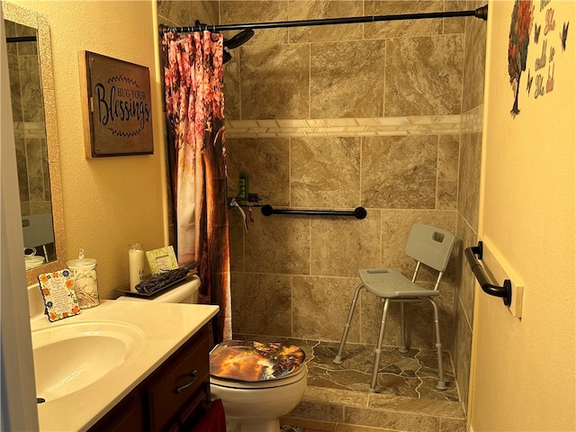 bathroom featuring vanity, toilet, and curtained shower