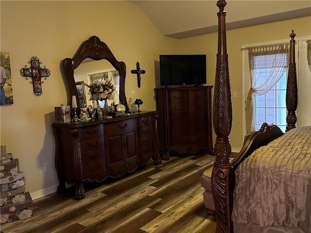 bedroom featuring dark wood-type flooring and lofted ceiling