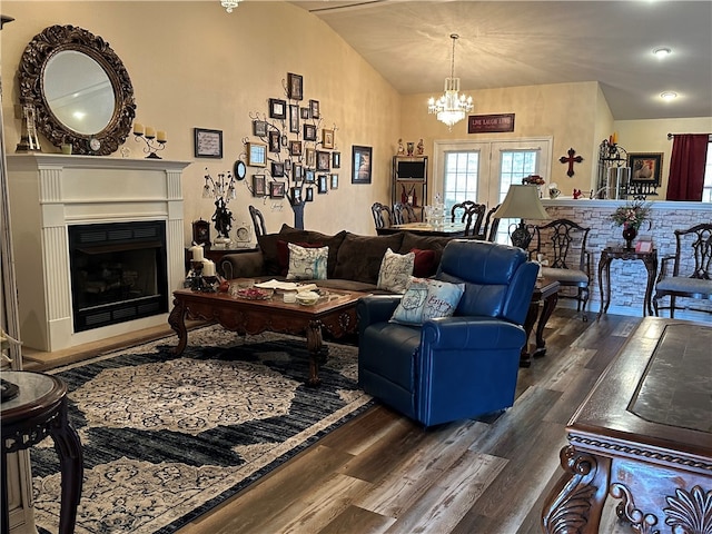 living room featuring vaulted ceiling, french doors, a notable chandelier, and dark hardwood / wood-style floors