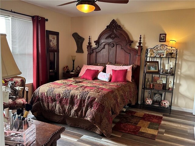 bedroom with multiple windows, hardwood / wood-style flooring, and ceiling fan