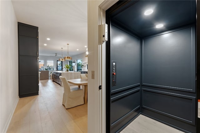 details featuring wood-type flooring and elevator