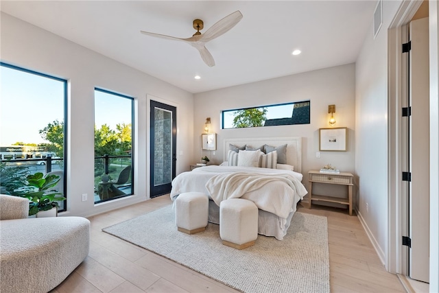 bedroom with access to exterior, ceiling fan, and light hardwood / wood-style floors