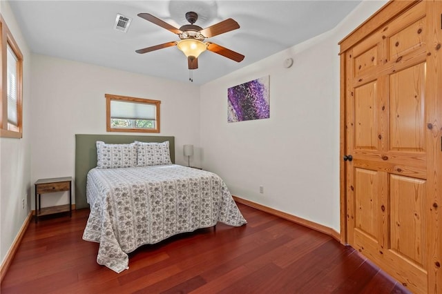 bedroom with a ceiling fan, dark wood-type flooring, baseboards, and visible vents