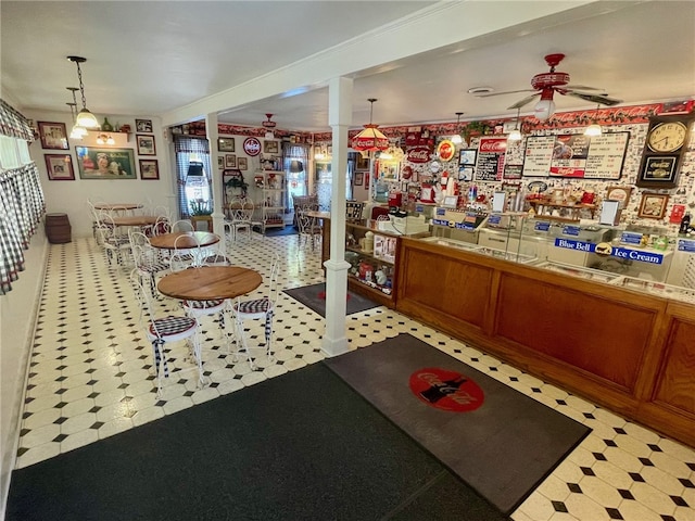 reception with decorative columns and ceiling fan