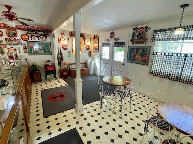 kitchen featuring ceiling fan and decorative columns