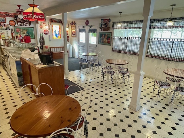 kitchen featuring hanging light fixtures and ornate columns