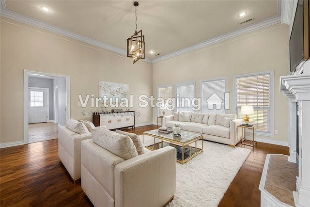 living room featuring ornamental molding, a notable chandelier, dark hardwood / wood-style flooring, and a healthy amount of sunlight