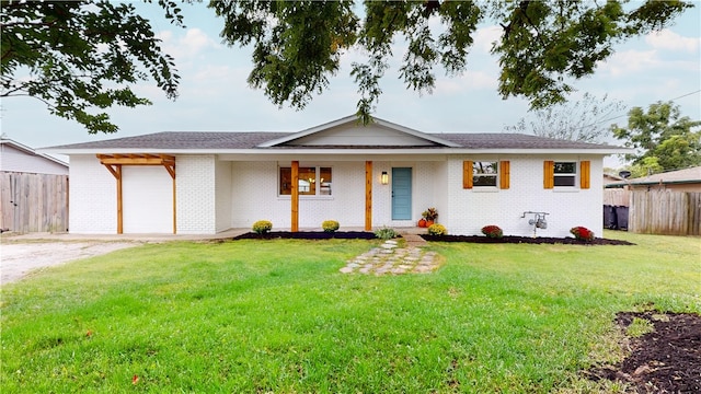 single story home with a garage and a front lawn