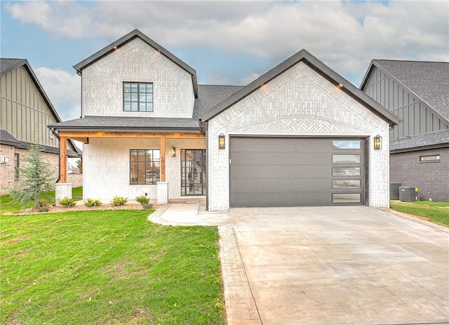 view of front of house with a garage, central AC, and a front yard