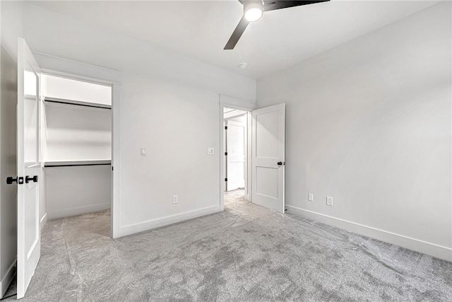 unfurnished bedroom featuring light carpet, ceiling fan, and a closet