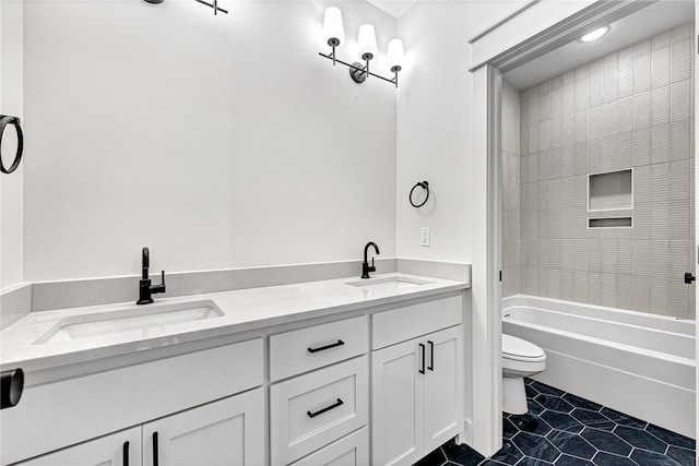 full bathroom featuring toilet, vanity, tiled shower / bath, and tile patterned floors