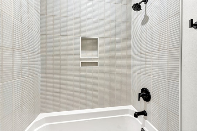 bathroom featuring tiled shower / bath