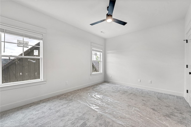 unfurnished room featuring ceiling fan and carpet flooring