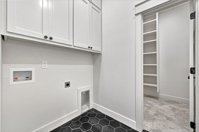 washroom featuring hookup for an electric dryer, hookup for a washing machine, cabinets, and dark tile patterned floors