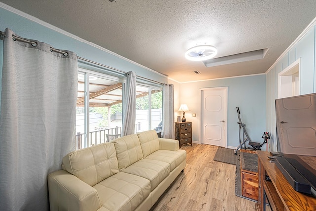 living room featuring a textured ceiling, crown molding, and light hardwood / wood-style floors