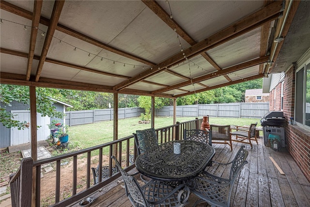 deck with a grill and a yard