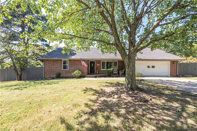 ranch-style home with a front lawn and a garage