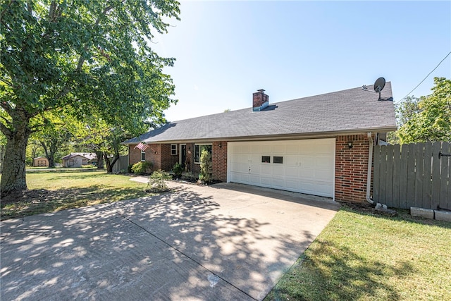 single story home with a garage and a front lawn