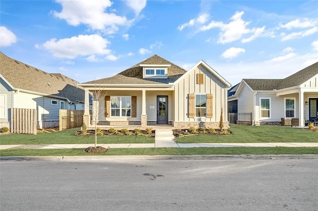 view of front of property with a porch and a front yard