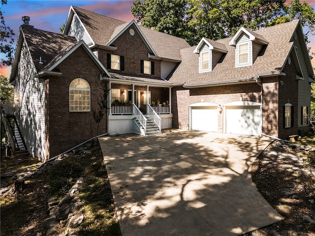 view of front of home featuring covered porch and a garage