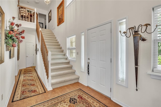 foyer entrance with a wealth of natural light and light hardwood / wood-style floors