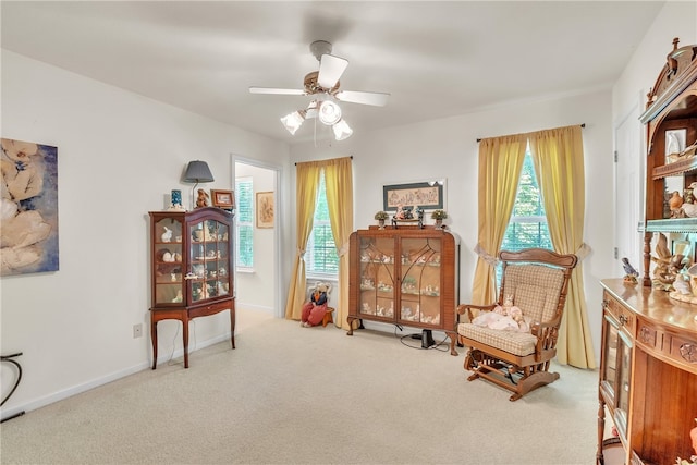 sitting room with carpet, a wealth of natural light, and ceiling fan