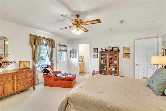 carpeted bedroom featuring ceiling fan and ensuite bathroom