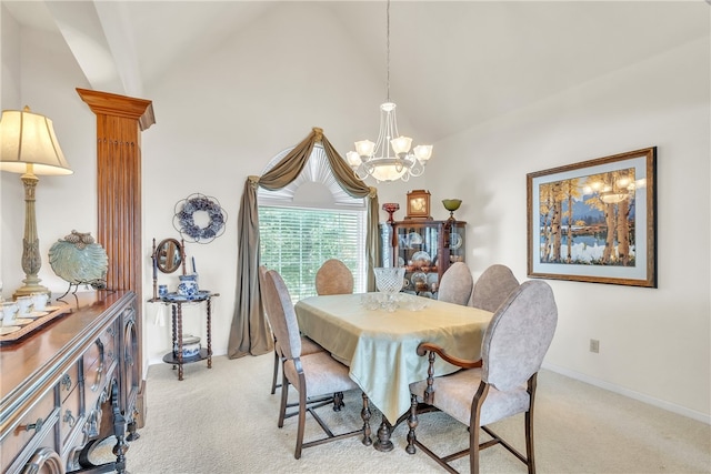 carpeted dining space with a chandelier, vaulted ceiling, and ornate columns