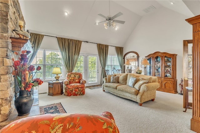 carpeted living room with high vaulted ceiling and ceiling fan