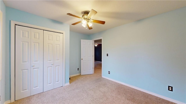 unfurnished bedroom with light carpet, ceiling fan, and a closet