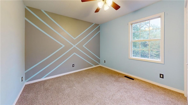 unfurnished room with ceiling fan and carpet flooring