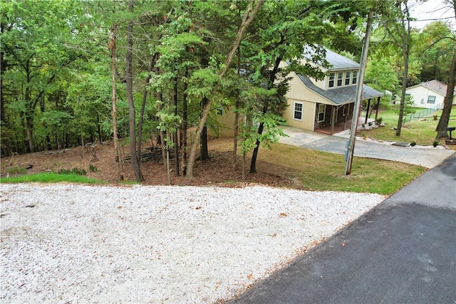 11566 Hickory Dr, Garfield, AR 72732 - view of front of house with asphalt driveway, covered porch, and a forest view
