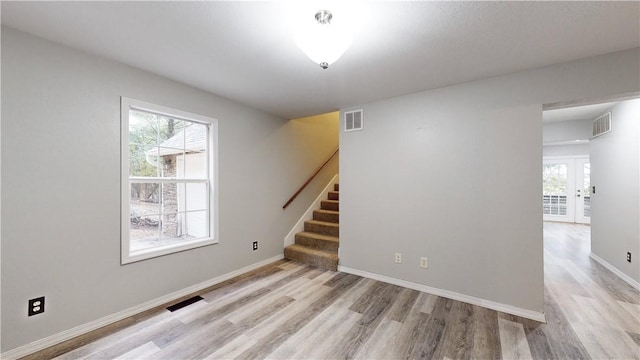 unfurnished room featuring light hardwood / wood-style floors