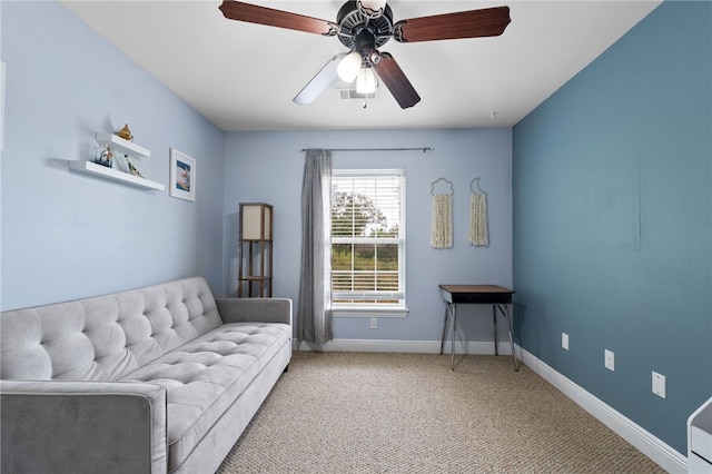 living area featuring light colored carpet and ceiling fan